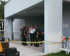 [Picture: Police at door]